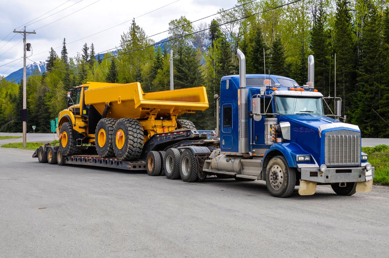 Heavy equipment secured on a lowboy trailer for oversized transport
