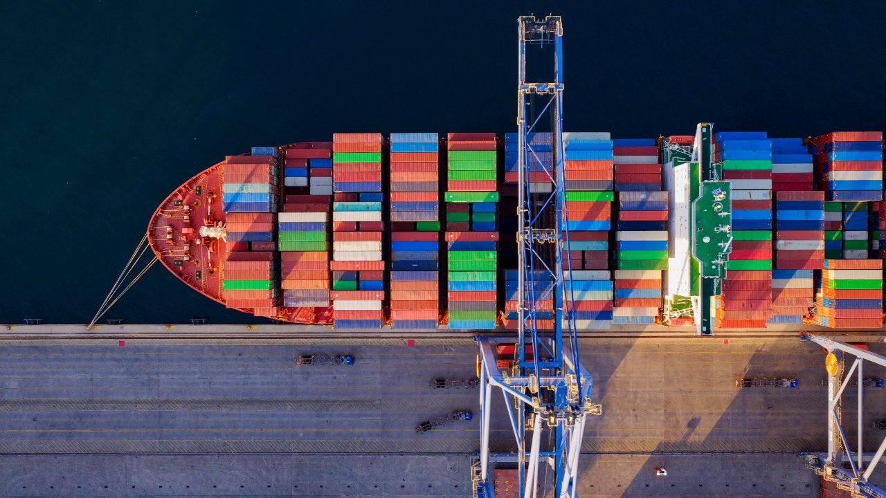 Container ship being worked at a port terminal.