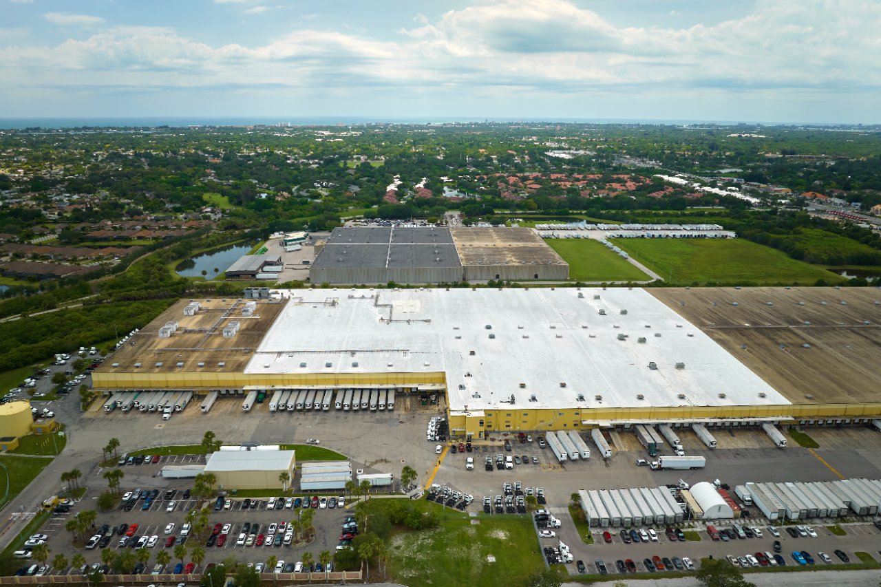 Aerial view of a large distribution center with loaded truck docks